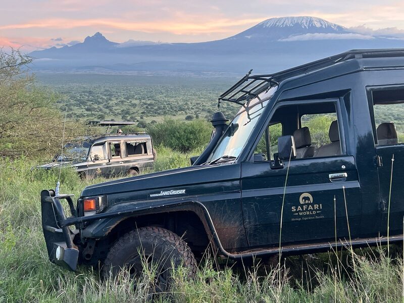Safari World vehicles with Kilimanjaro sunset in background