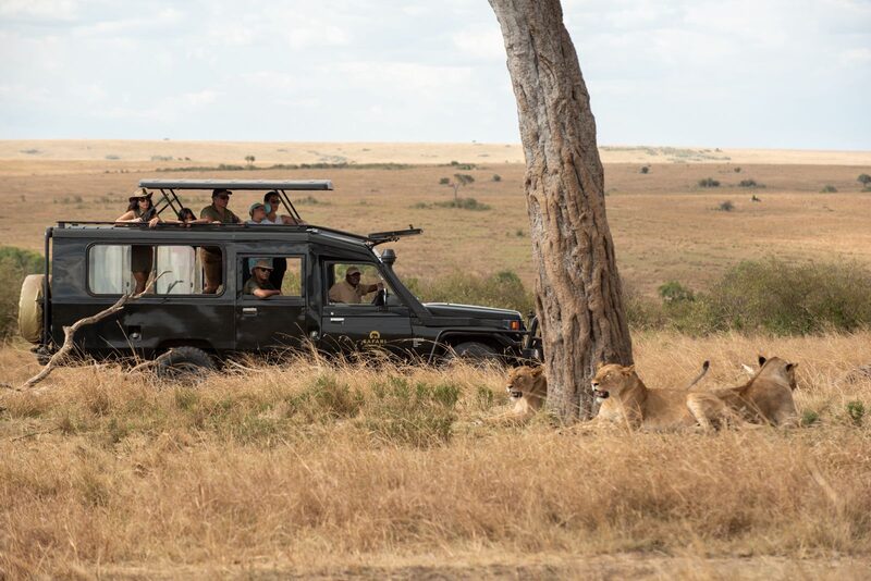 Safari World vehicle next to lions in the Masai Mara