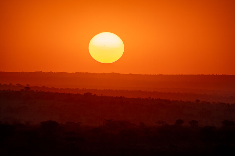 African sunset over layered ridges
